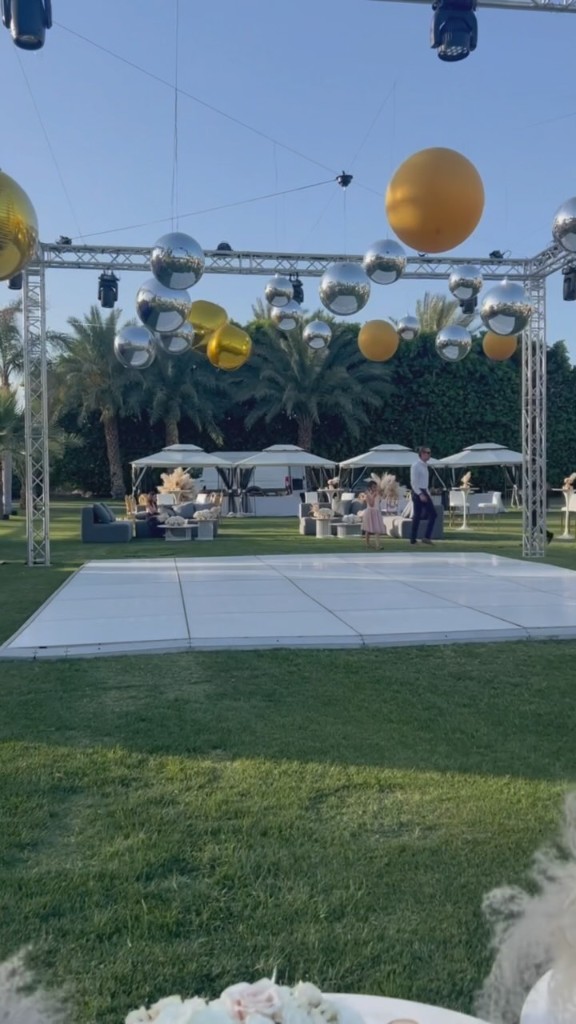 Pastel first-birthday backdrop with cake, balloons, and vintage bicycle