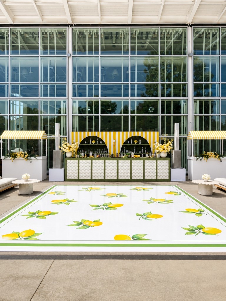 Lemon-themed outdoor bar, lounge, and patterned dance floor under a glass pavilion