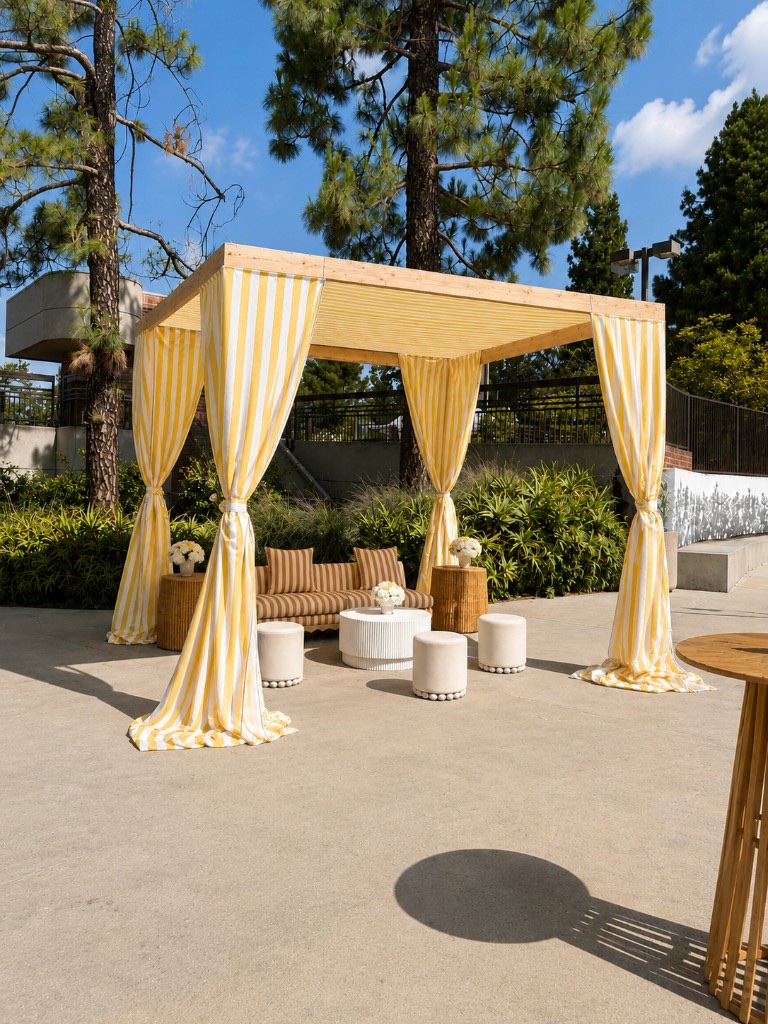 Yellow-and-white striped pergola lounge with sofa, stools, and patio seating