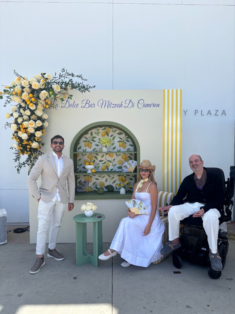 Lemon-themed La Dolce Bar Mitzvah backdrop with guests posing in front